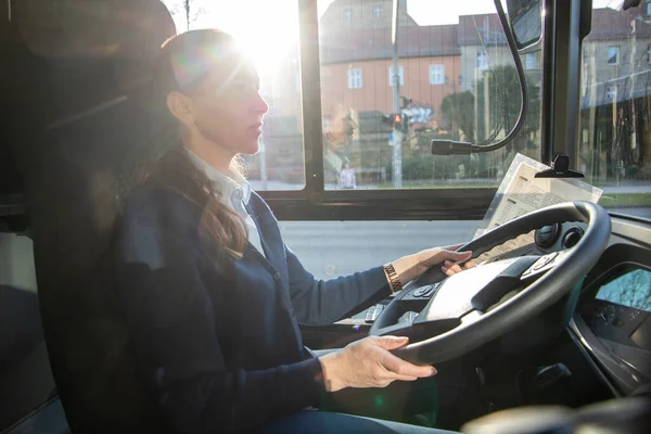 female bus driver driving a bus