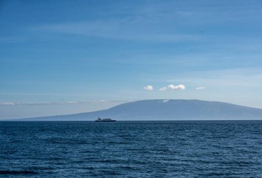 uninhabited islands of the Galapagos orchipelago from a safari ship on the background of the sea 