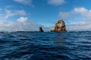 landscape with uninhabited islands of the Galapagos archipelago against the backdrop of a calm and blue ocean