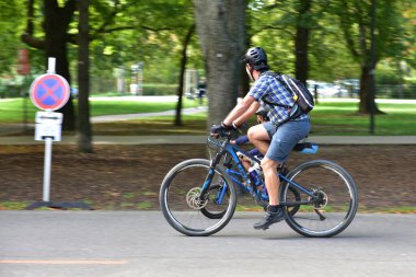 Father and child - cyclists in the Prater Hauptallee in Vienna, Austri