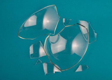 Pastel mavi yeşil arka planda kırık cam parçaları. Kapat, üst görünüm.