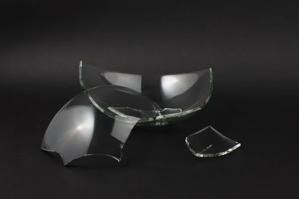 Gebroken glasstukken op zwarte ondergrond. — Stockfoto