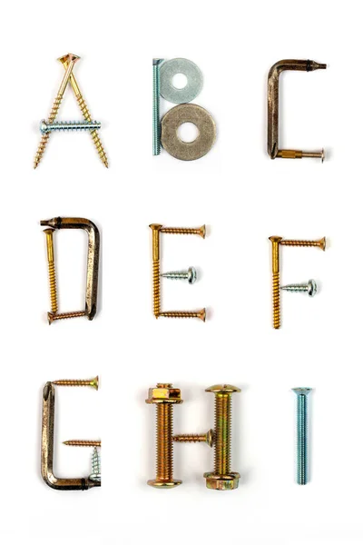Industrial alphabet. Letters A, B, C, D, E, F, G, H, I, made of nails and screw. — Stock Photo, Image