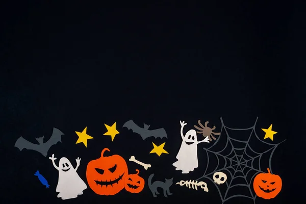 Halloween horizontal border. Funny halloween characters on black paper. Copy space. Paper cut collage.