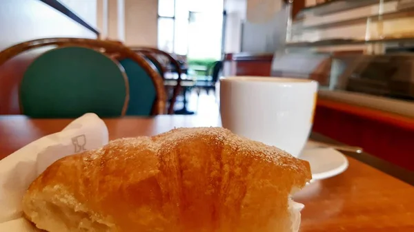 Breakfast in the foreground, brioche and cup of coffee, breakfast, Italian restaurant.