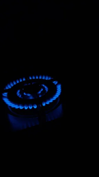 Flame Gas, Household energy consumption. Black color background. Increased costs in the bill.