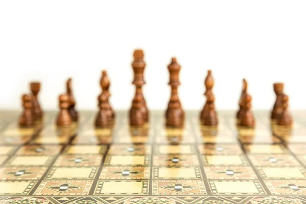 Chess pieces on a beautiful chessboard, isolated on white background — Stock Photo, Image