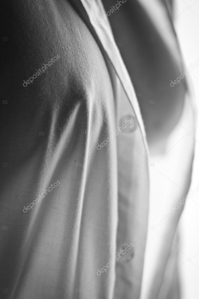 Breasts showing through a white shirt, black and white Stock Photo
