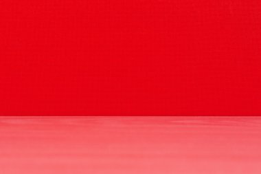 Wooden modern table on red textured background
