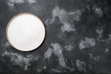 Metin ya da yiyecek için kopyalama alanı olan boş yemek tabağı seti, üst görünüm düz, siyah taş masa arkaplanı üzerine