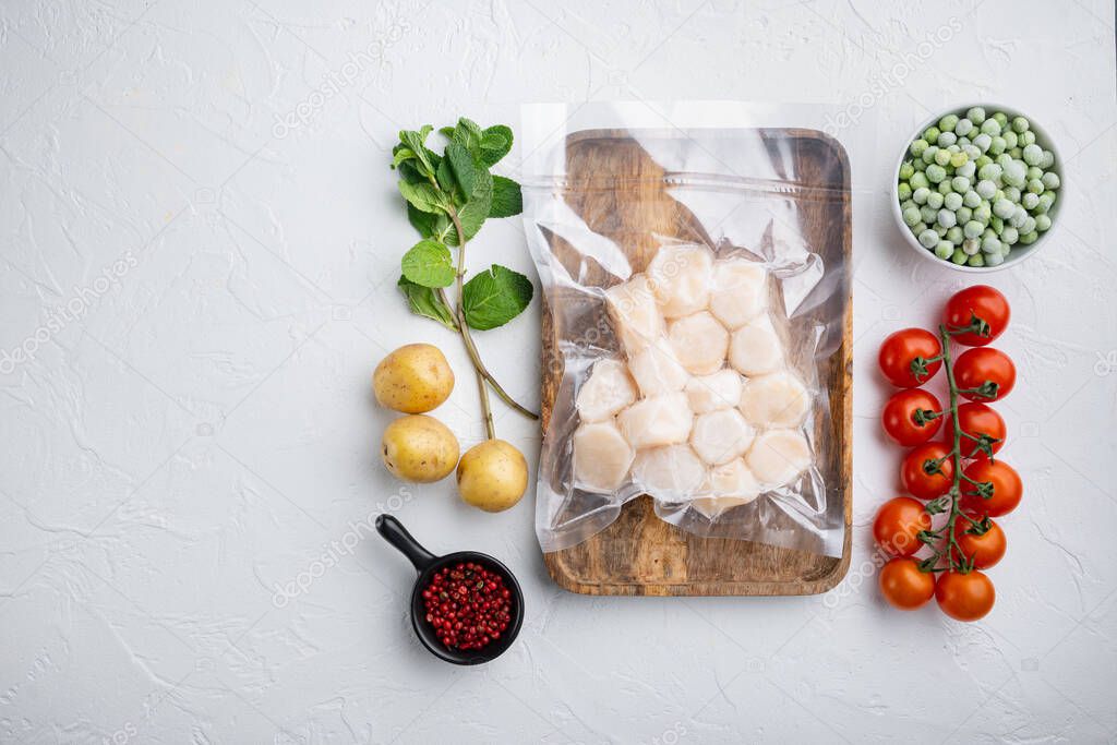 Scallops, in vacuum pack, top view, on white textured background  with copy space
