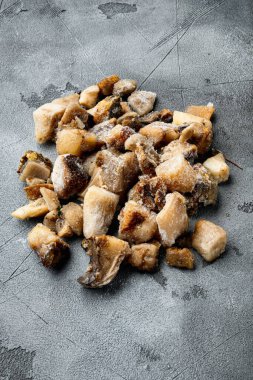 Gri taştan arka planda donmuş yabani mantarlar.