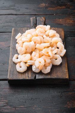 Boiled Peeled Shrimps, Prawns set, on wooden serving board, on old dark  wooden table