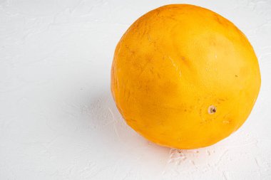 Honeydew melon set, on white stone table background, with copy space for text