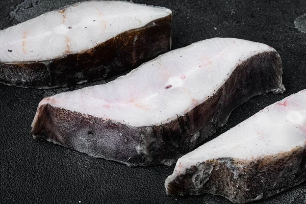 Frozen fish cut set, on black dark stone table background