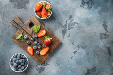 Fresh summer berrie, on gray background, top view flat lay with copy space for text