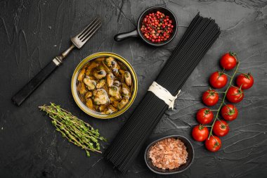 Ingredients for making pasta with seafood set, on black dark stone table background, top view flat lay