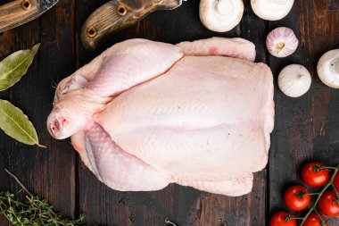 Whole chicken set, on old dark  wooden table background, top view flat lay