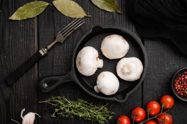 Fresh white champignon mushrooms set, on black wooden table background