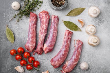 Raw chicken neck set, on gray stone table background, top view flat lay