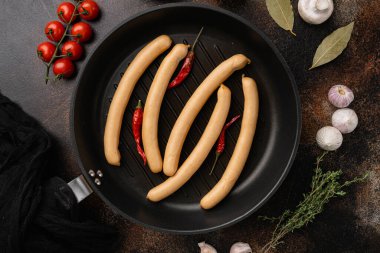 Classic boiled meat pork sausages set, on old dark rustic table background, top view flat lay