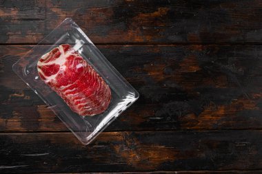 Sliced Ham Salami coppa plastic pack set, on old dark  wooden table background, top view flat lay, with copy space for text