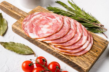 Sliced raw smoked sausage set, on white stone table background