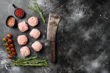 Raw ground beef meat steak cutlets set, on black dark stone table background, top view flat lay, with copy space for text