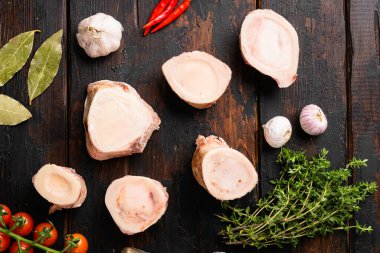 Beef Bones for Making Broth set, on old dark  wooden table background, top view flat lay