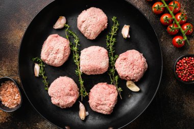 Fresh raw turkey meatballs set, on old dark rustic table background, top view flat lay