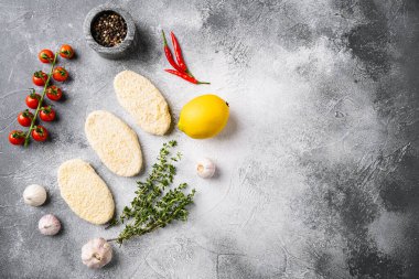 Round fresh fish cakes set, on gray stone table background, top view flat lay, with copy space for text
