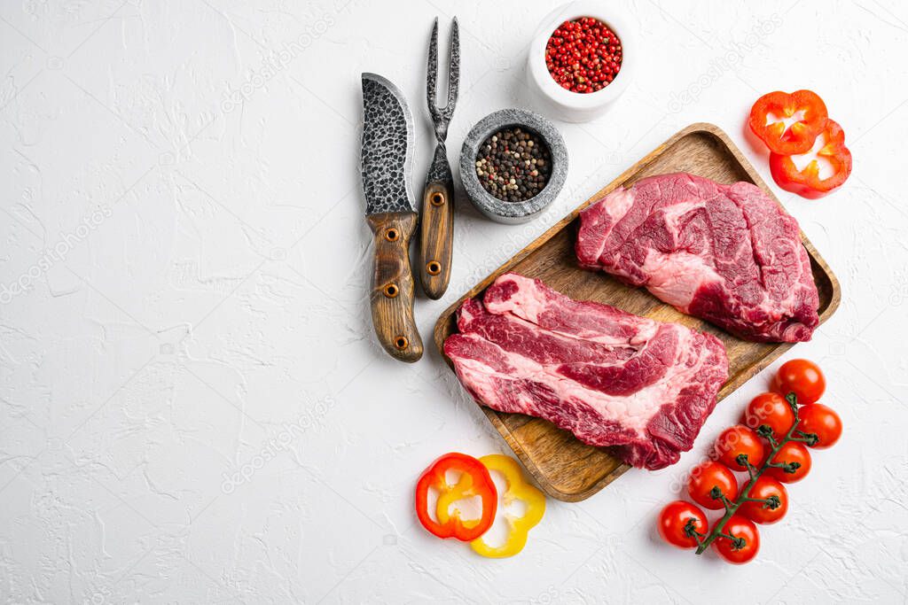 Fresh  chuck roll steak set, on white stone table background, top view flat lay, with copy space for text