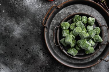 Donmuş ıspanak blokları seti, siyah koyu taş masa arkaplanı, üst görünüm düz yatay, metin alanı için kopyalama alanı