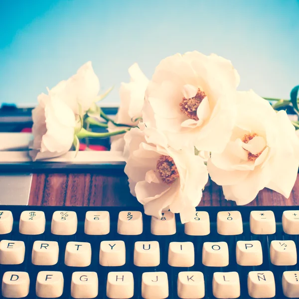 Skrivmaskin och blommor — Stockfoto