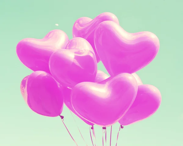 Purple heart balloons on mint sky — Stock Photo, Image