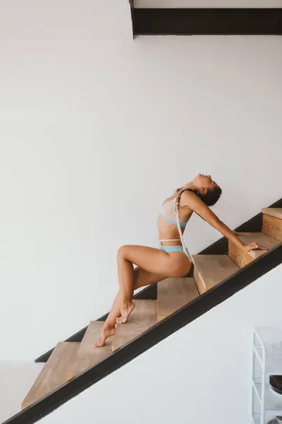 Sexy girl posing on the steps in the lingerie. — Stock Photo, Image