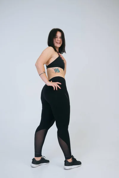 Ung överviktig kvinna med vit bakgrund. Kroppsligt positivt begrepp. — Stockfoto