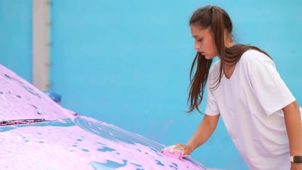 Uma jovem loira lava seu carro — Vídeo de Stock