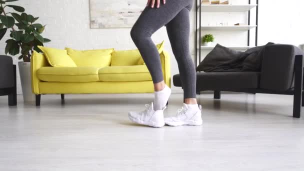 Close-up van jonge actieve fitness meisjes het nemen van sneakers, home. — Stockvideo