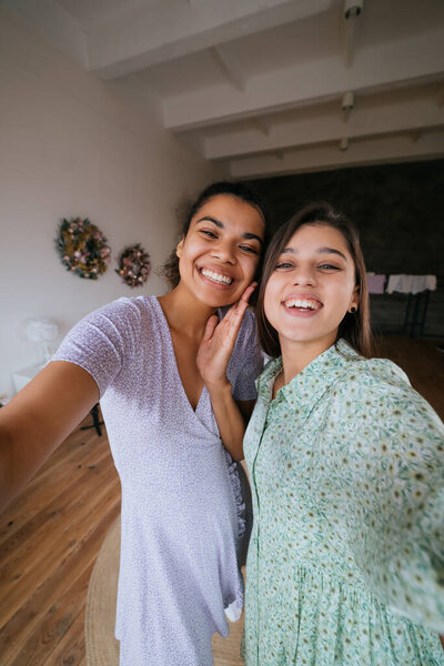 Two girls take selfies in the living room Stock Photo
