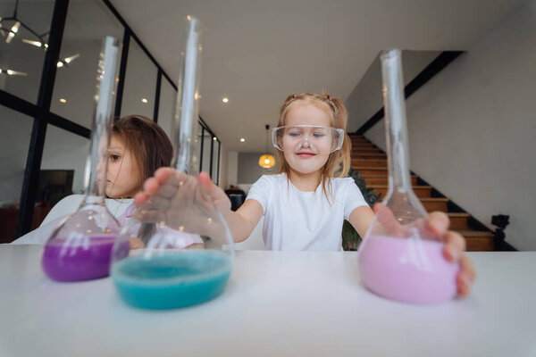 Little girls making chemical experiments at home Royalty Free Stock Images