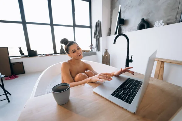 Young Woman Working Laptop While Taking Bathtub Home — Stok fotoğraf