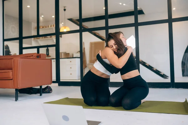 Two Girlfriends Hug Each Other Yoga Home — Foto Stock