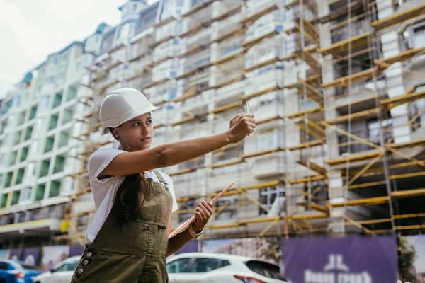 Woman construction engineer wear safety white hard hat at construction site industry worker. Woman construction Engineer concept