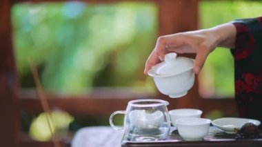 Process brewing tea. Woman steeping herbal tea and enjoying a slow afternoon.