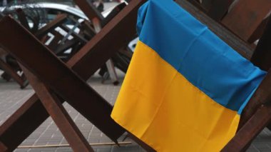 The Ukrainian flag hangs on barricades on the street