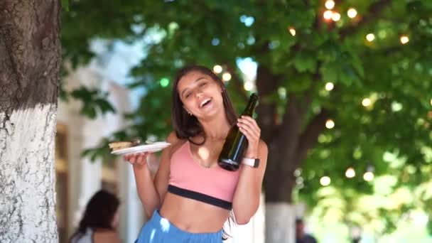 Young Woman Carries Plate Snacks One Hand Drink Other — 图库视频影像