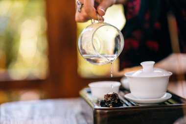 Process brewing tea. Woman steeping herbal tea and enjoying a slow afternoon.