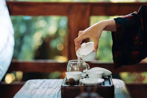 Process brewing tea. Woman steeping herbal tea and enjoying a slow afternoon.