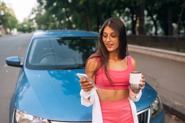 Woman drive car stop coffee break pause , use smartphone read social network news in city center